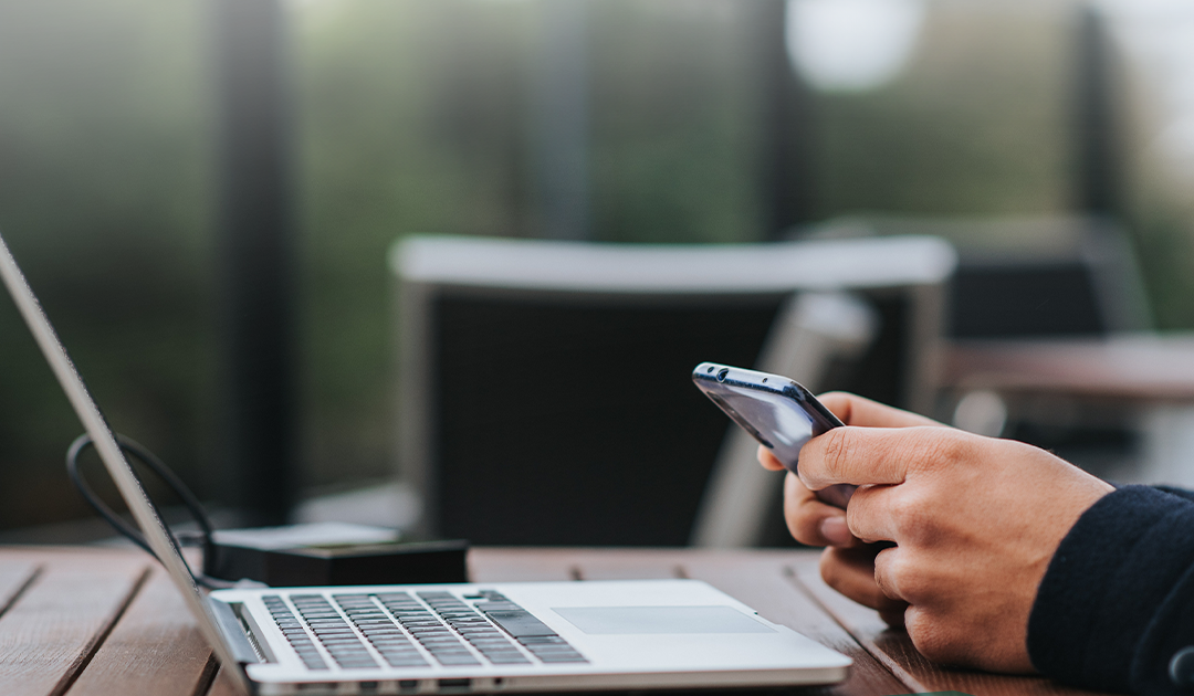 Forte campaign visual — an investor reviewing holdings on a phone beside an open laptop.