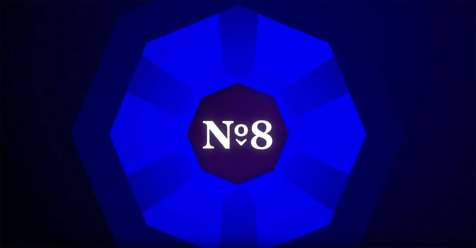 Still from the Store Nº8 brand story film — the Nº8 octagon mark radiating against a deep blue field.